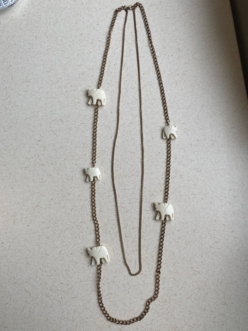 Long Double gold tone chain necklace featuring ivory white elephants 32” long